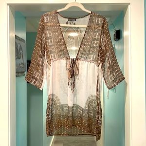 Sheer bathing suit coverup. Small tear on waist and bottom of left sleeve.